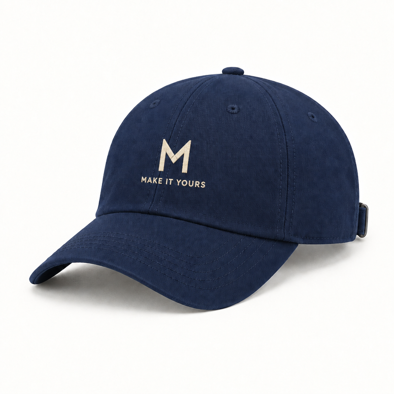 Navy baseball cap mockup with embroidered M and MAKE IT YOURS text