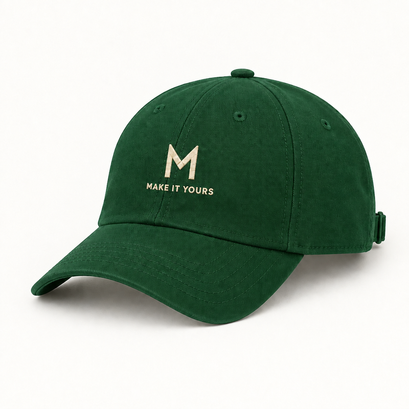 Forest green baseball cap mockup with embroidered M and MAKE IT YOURS text
